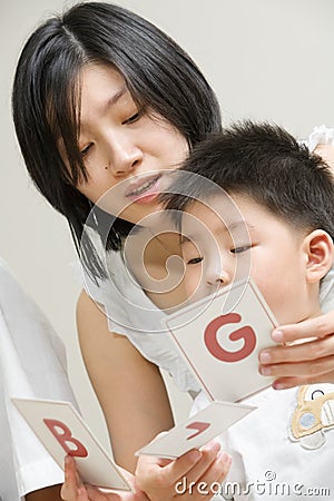 Mother tutoring her son Stock Photo