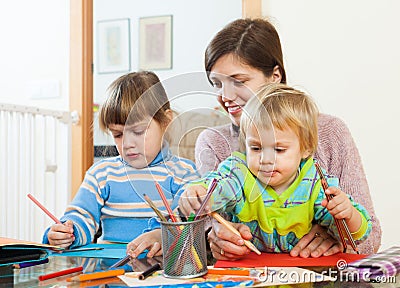 Mother and two children together with pencils Stock Photo