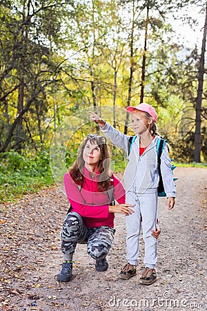 Mother walking with her child in warm sunny autumn day Stock Photo