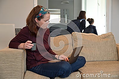 Mother working from home while children going to school Stock Photo