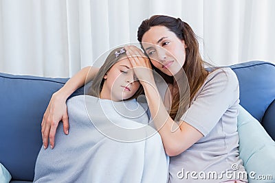 Mother worrying about sick daughter Stock Photo