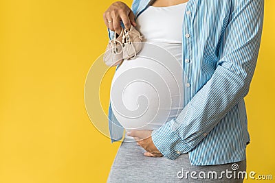 Motherhood, femininity, love, care, waiting, hot summer - bright croped Close-up unrecognizable pregnant woman in shirt Stock Photo