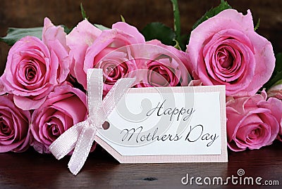 Mothers Day pink roses on rustic dark wood table. Stock Photo