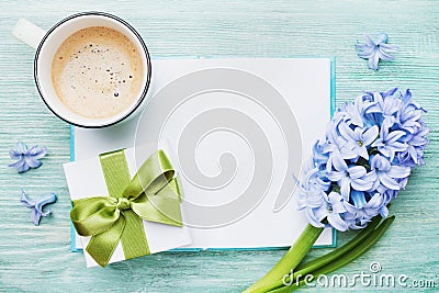 Mothers Day spring holiday card with empty notebook for greeting text with cup of coffee, gift or present box and hyacinth flowers Stock Photo