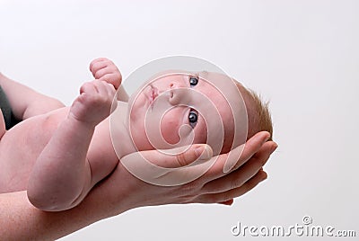 Mothers hand holding a baby head Stock Photo