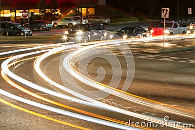 Motion Blur Of Car Headlights Turning At Busy Intersection Stock Photo
