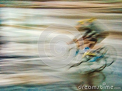 Motion blur of cyclist in the rain Stock Photo