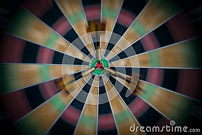 Motion Blur on a Dartboard with Three Darts in the Bull`s Eye Stock Photo