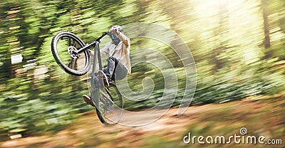 Motion blur of mountain bike man, action jump and bicycle speed adventure, freedom and fast race in woods. Cycling Stock Photo