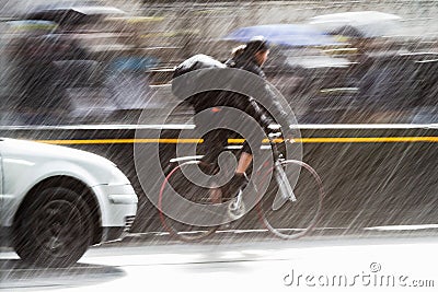 Cyclist on a city street at heavy rain Stock Photo