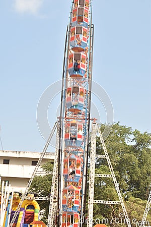 A motion blur view giant wheel or ferris wheel with the background of blue sky at india Editorial Stock Photo