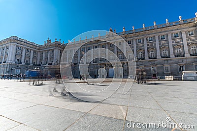 Motion blured people walking in front of Palacio Real Royal palace in a winter sunny day Editorial Stock Photo