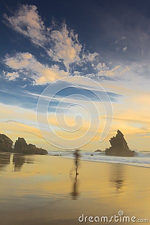 Fisherman in adraga beach at sunset Stock Photo