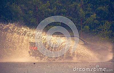 Motion car rain big puddle of water spray Editorial Stock Photo