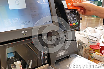 Motion of people paying credit card at check out counter Editorial Stock Photo