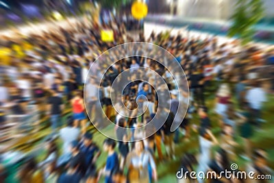 Motion radius blur about people joined the outdoor concert at the night Stock Photo