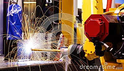 Motion Welding robots in factory with sparks, manufacturing, industry, factory Stock Photo