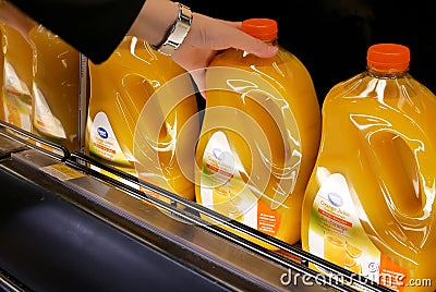 Motion of woman buying great value orange juice inside Walmart store Editorial Stock Photo