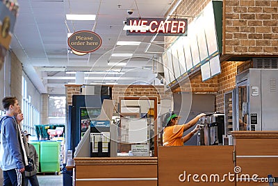 Motion of worker preparing sandwich for customer inside subway restaurant Editorial Stock Photo