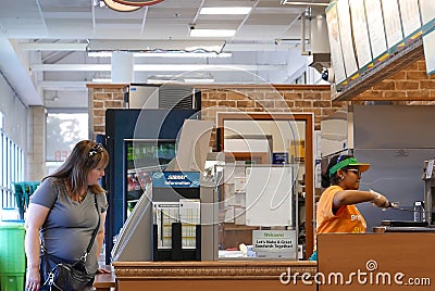 Motion of worker preparing sandwich for customer inside subway restaurant Editorial Stock Photo