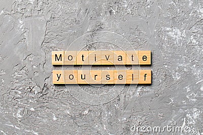 Motivate yourself word written on wood block. motivate yourself text on cement table for your desing, concept Stock Photo