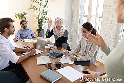 Motivated Arabic female employee participate in group discussion Stock Photo
