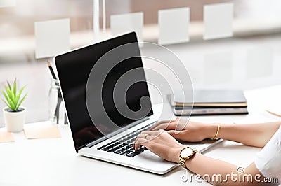 Motivated business woman focusing on project while using laptop computer, Cropped shot photo Stock Photo