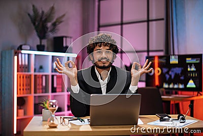 Motivated confident businessman in formal wear meditating and mudra hands Stock Photo
