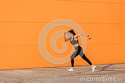 Motivated confident fit woman athlete in tight sportswear, black pants and top, starting to run, jogging outdoor Stock Photo