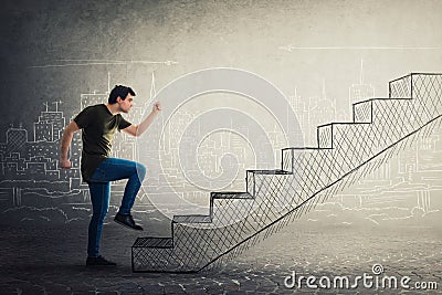 Motivated and confident young man hurry to climb a imaginative staircase Stock Photo