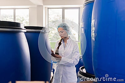Manufacturing employee writing report during quality control in Stock Photo