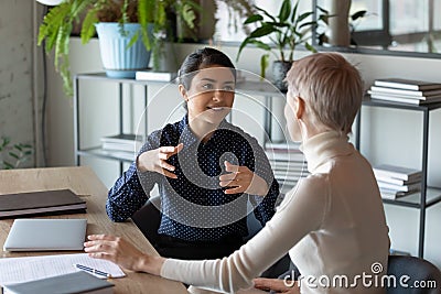 Motivated multiracial colleagues talk brainstorm at workplace Stock Photo