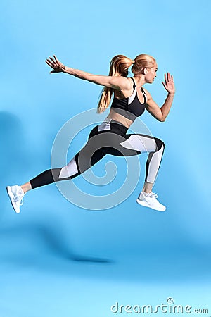 Motivated woman runner on blue background. Stock Photo