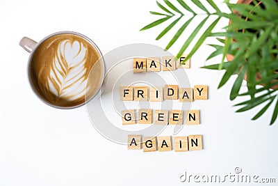 Motivating slogan Make Friday green again. Wooden letters. Top view. Coffee and eucalyptus Stock Photo