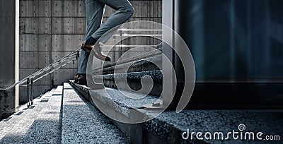 Motivation and challenging Concept. Steps Forward into a Success. Low Section of Businessman Walking Up on Staircase Stock Photo