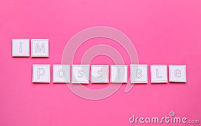 Motivation concept. Changing word from Impossible into Possible by removing paper with letters I and M on pink background, top Stock Photo