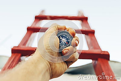 Motivation, search and movement towards the goal. Self-realization concept. A man with a compass is looking for direction on Stock Photo