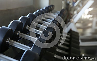 Motivation for Sport. Dumbbell sets in the gym. Sports equipment on a gymnasium background. Side view. Selective focus Stock Photo