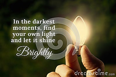 Motivational quote about darkest moments with closeup light bulb background Stock Photo