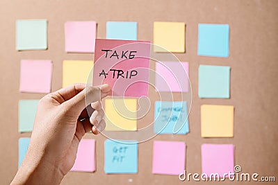 Motivational word `Take a trip` on pink card. Stock Photo