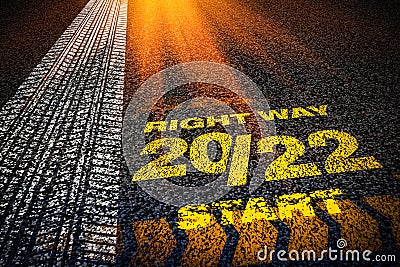 2022 tyre track. Motivational writing 2022 on asphalt as a metaphor for moving forward and happy new year Stock Photo