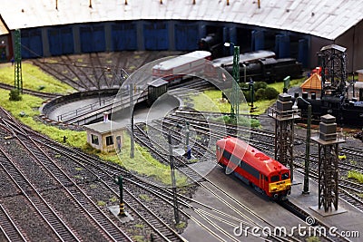 A miniature locomotive depot with railroad tracks, locomotives and buildings.. Editorial Stock Photo