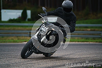 Moto-athlete on the racetrack. Motorcycle sport. No logo or brand names. No any intelectual property Stock Photo