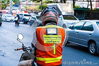 Moto taxi driver in bangkok. View from the back, a man in a vest with a pocket of a taxi driver s license Editorial Stock Photo