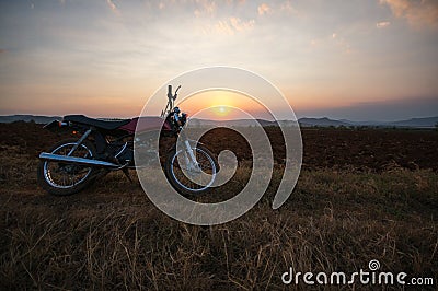 The motobike on the field, sunset in country and beatyful cloud on sky Dalat city - in LamDong- VietNam Editorial Stock Photo