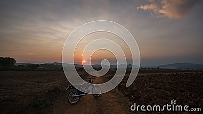 The motobike on the field, sunset in country and beatyful cloud on sky Dalat city - in LamDong- VietNam Editorial Stock Photo