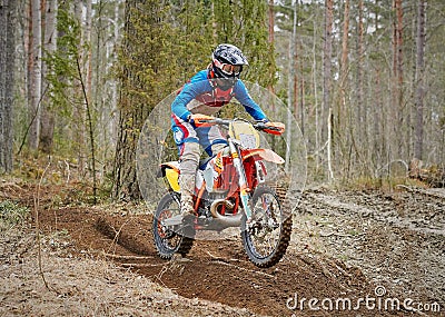 Motocross driver accelerating the motorbike on the race track Stock Photo
