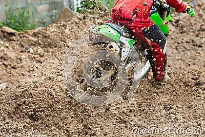 Motocross,enduro rides through the mud with big splash,driver splashing mud on wet and muddy terrain, Stock Photo