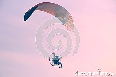 Motoparaplane against the sky and the sun. Extreme sports, enjoy life, value the moment, Fly towards the sun Editorial Stock Photo