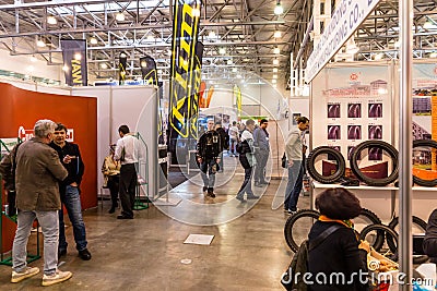 Motopark-2015 (BikePark-2015). The general view. Visitors of the exhibitions are looking stands. Editorial Stock Photo
